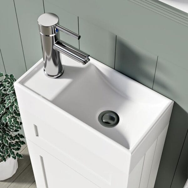 Space-saving white bathroom vanity unit with a soft-close door and internal shelves