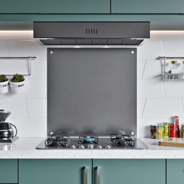 Front view of a stainless steel splashback installed in a stylish kitchen with white tiles