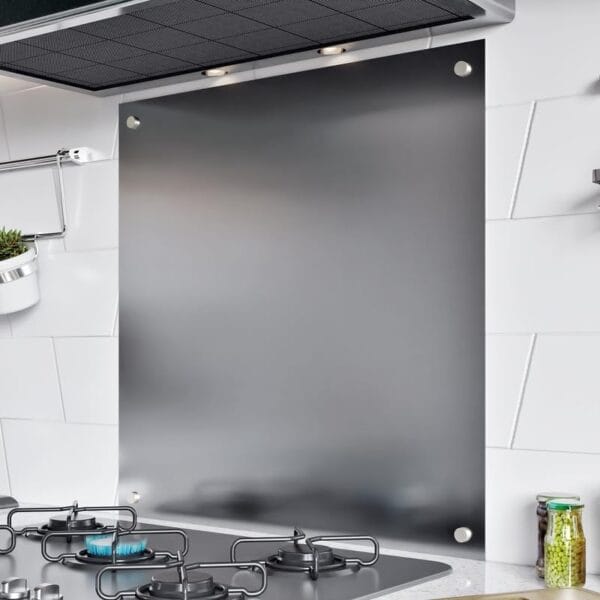 Stainless steel splashback installed behind a gas hob, reflecting under-cabinet lighting in a modern kitchen