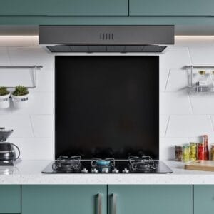 A fully installed stainless steel splashback behind a gas stove, complementing a contemporary kitchen design