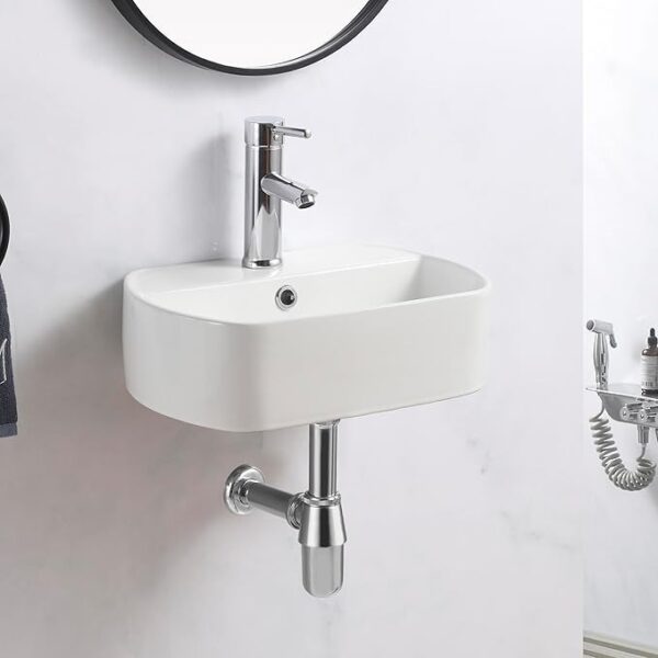 Modern white ceramic wall hung basin with pop-up waste and bottle trap