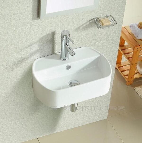 Modern white ceramic wall hung basin with pop-up waste and bottle trap